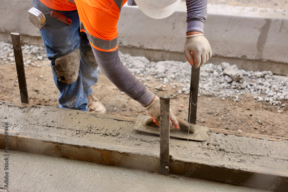 worker with trowel finishes the concrete worker with trowel finishes the concrete