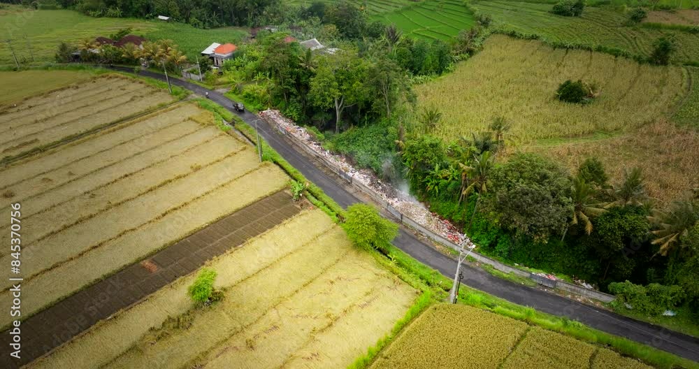 Top aerial view of smoldering garbage pile dumped on side of Bali country road Top aerial view of smoldering garbage pile dumped on side of Bali country road