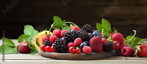 Fresh summer berries and fruits assortment on the wooden plate. Creative banner. Copyspace image