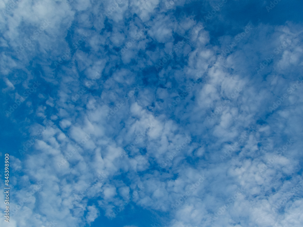 Bright sky texture background with white clouds, pleasing to the eye.