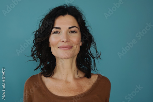 A close up portrait of a woman with a subtle smile