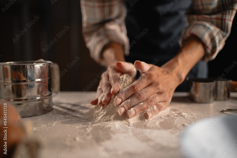 Hands delicately kneading dough in a charming rustic kitchen to prepare homemade bread Hands delicately kneading dough in a charming rustic kitchen to prepare homemade bread
