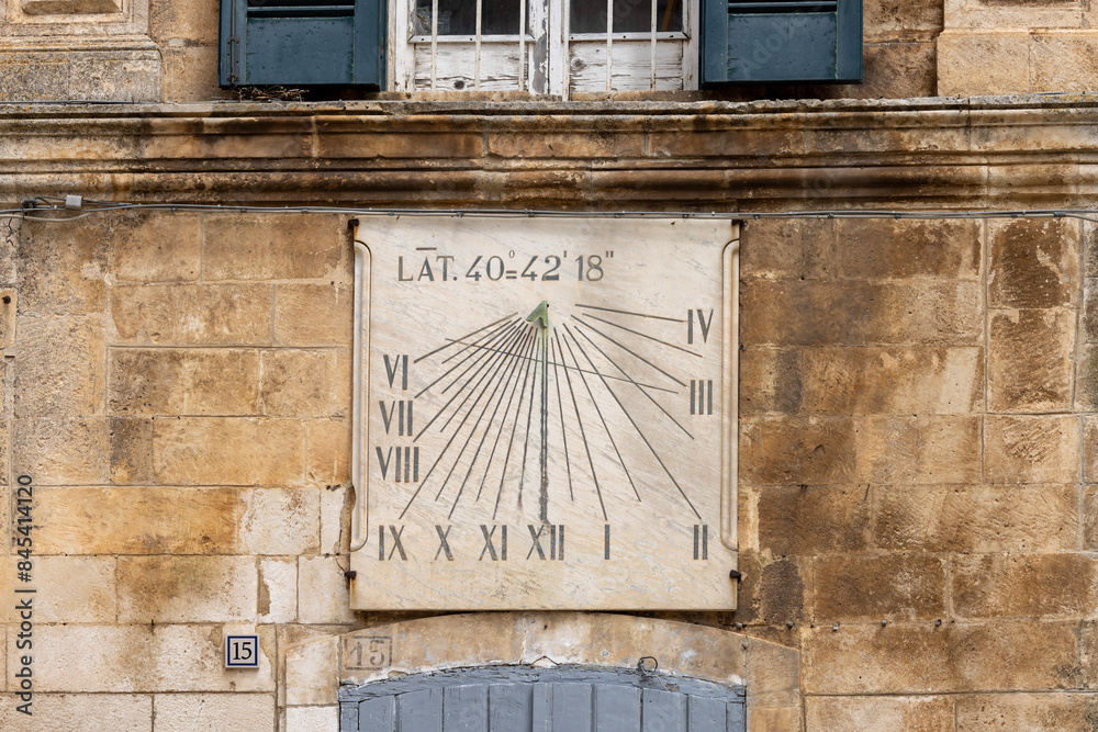 Sundial on facade of Civic Tower (Torre dell'Orologio) and University Palace, located in Plebiscito Square, Martina Franca, Italy, Puglia