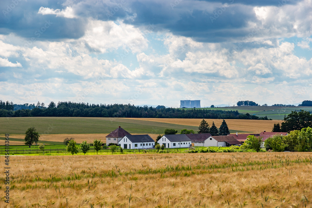 Czech village in summer day. Nuclear power plant Temelin on a horizon. Czech village in summer day. Nuclear power plant Temelin on a horizon.