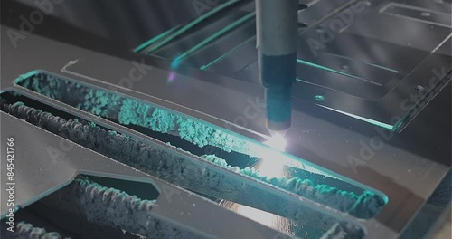 A plasma cutter cuts a detail, close-up. The work of the CNC plasma cutter. The work of a plasma cutter close-up. photo