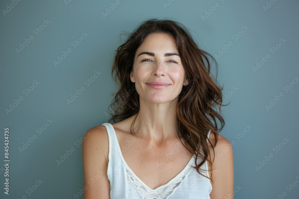 A close up portrait of a woman with a subtle smile A close up portrait of a woman with a subtle smile