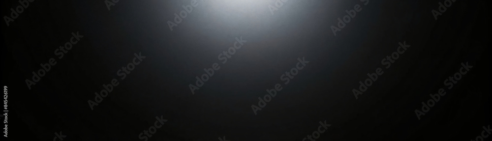 Dark metallic backdrop with a spotlight beam cutting through the textured surface Dark metallic backdrop with a spotlight beam cutting through the textured surface
