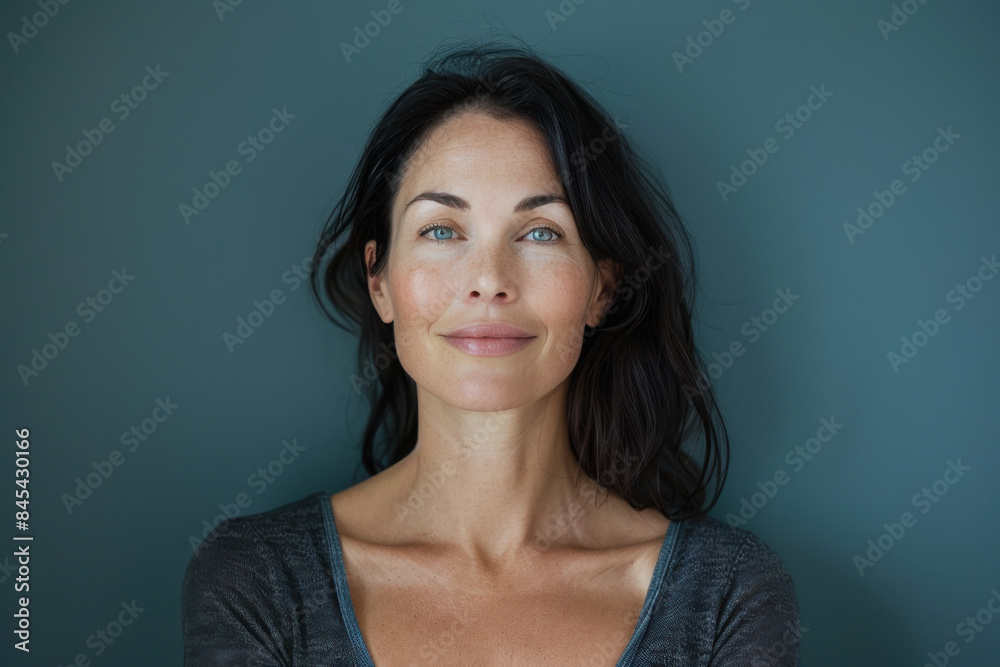 A close up portrait of a woman with a subtle smile A close up portrait of a woman with a subtle smile