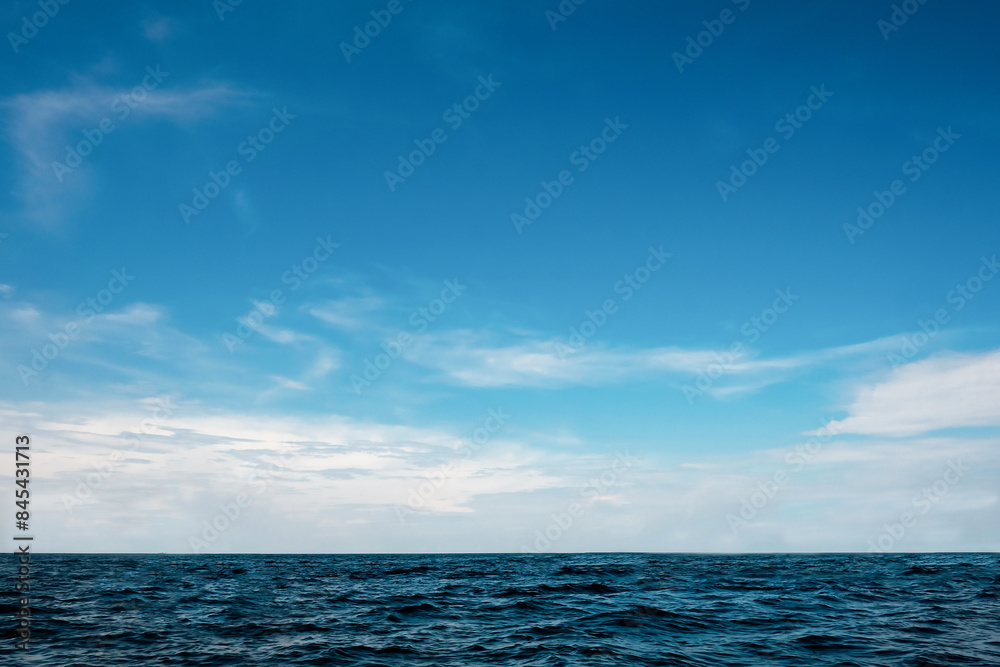 Obraz premium Panorama nature view clear sky with soft white cloudy background and soft oceans waves with a deep blue color on the sea