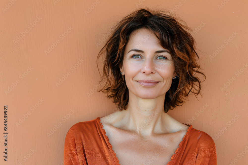 A close up portrait of a woman with a subtle smile A close up portrait of a woman with a subtle smile