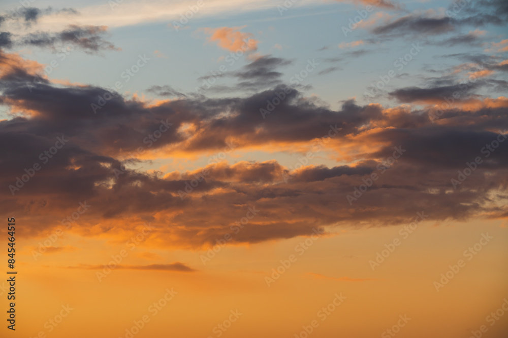Orange-violet clouds at sunset sky in Estonia, photo background texture. Orange-violet clouds at sunset sky in Estonia, photo background texture.