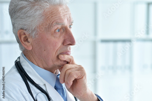 Portrait of confident senior male doctor in office