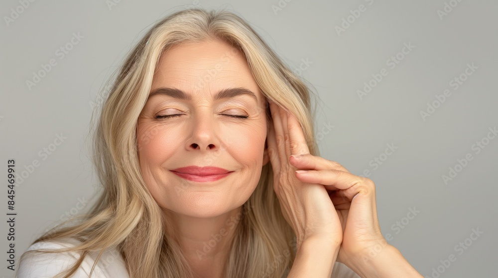 Georgeous cheerful middle aged mature woman with hands on her face enjoying perfect skincare and skin as self love and care concept Georgeous cheerful middle aged mature woman with hands on her face enjoying perfect skincare and skin as self love and care concept