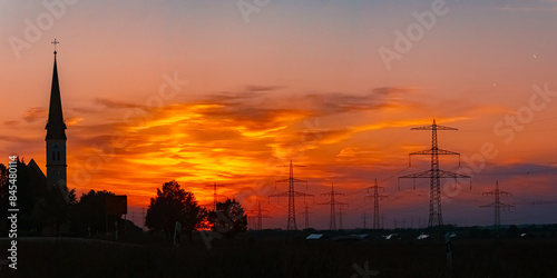 High resolution stitched summer sunset panorama with a church silhouette near Wallerdorf, Künzing, Deggendorf, Bavaria, Germany © Martin Erdniss