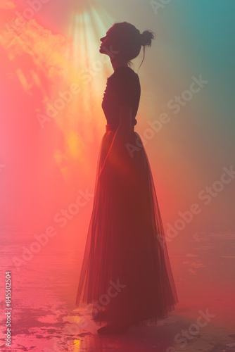 Elegant silhouette of a female figure standing tall on a soft pastel background, © Oleksandr