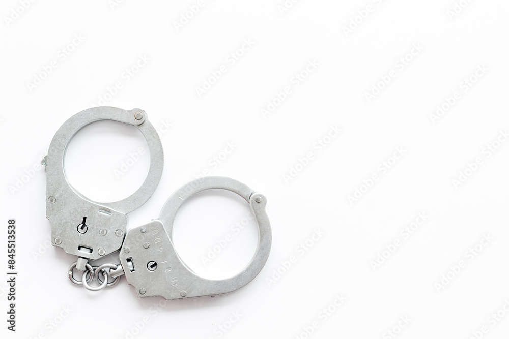 Close up police metal handcuffs, top view. Criminal law and justice concept Close up police metal handcuffs, top view. Criminal law and justice concept