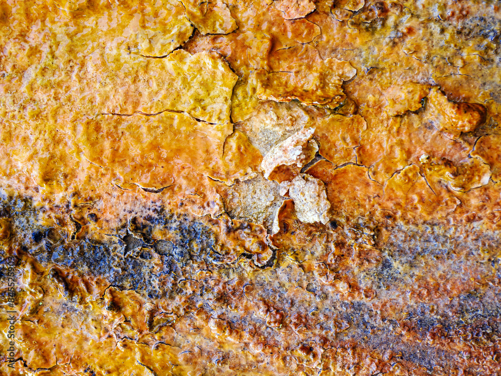 Close-up background of the rough peeling surface of Groundwater stains or raw water that has algae Yellow-red sediment, rust, iron, clinging to the cement pipe, abstract pattern. Close-up background of the rough peeling surface of Groundwater stains or raw water that has algae Yellow-red sediment, rust, iron, clinging to the cement pipe, abstract pattern.