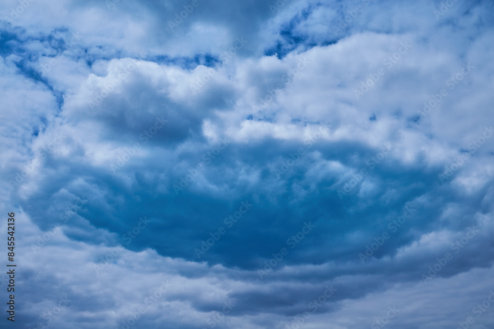 Obraz premium Blue cloud vortex in sky, close-up, hurricane formation, cloud funnel