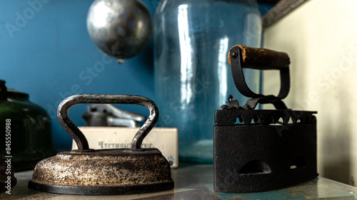 Vintage iron collection with antique irons in rustic setting, showcasing craftsmanship and history