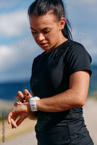 Close Up Woman Analyzing Workout Data on Smartwatch Post Run.
