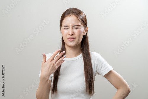 Sweaty young woman feeling discomfort and hot isolated on background