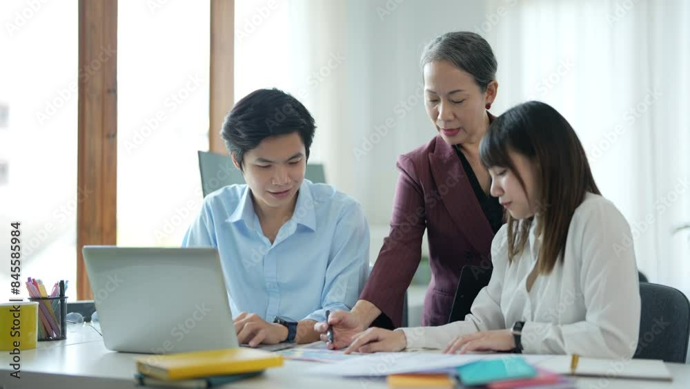 Group of asian business people working together, brainstorming in office Group of asian business people working together, brainstorming in office