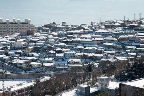 View of the snow-covered town at the seaside photo