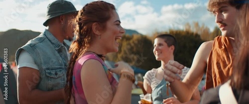 Excited young friends greeting and hugging at a festival