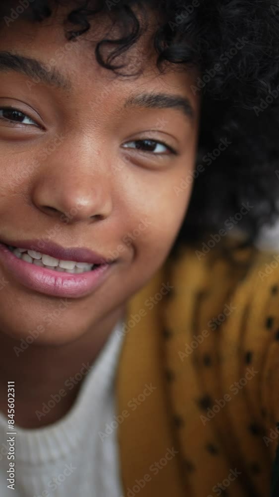 Portrait of cute African American teenager calling by video conference in mobile app, looking at camera. Vertical video, black adolescent chatting cheerfully with friends by phone, smiling broadly Portrait of cute African American teenager calling by video conference in mobile app, looking at camera. Vertical video, black adolescent chatting cheerfully with friends by phone, smiling broadly