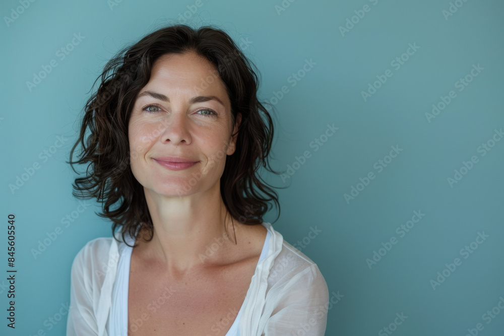 A close up portrait of a woman with a subtle smile A close up portrait of a woman with a subtle smile