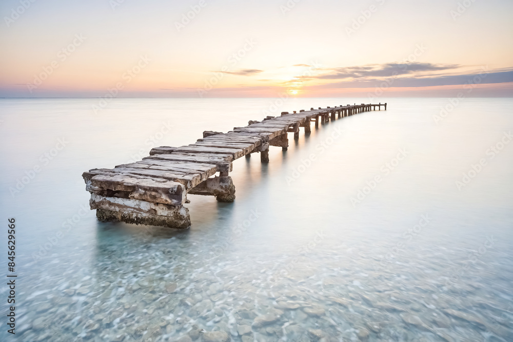 Wooden Pier Extending Into the Ocean at Sunset Wooden Pier Extending Into the Ocean at Sunset