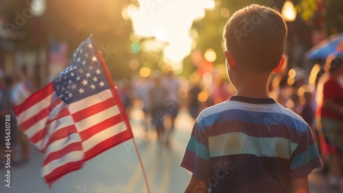 Young boy with flag in evening, outdoor event photo