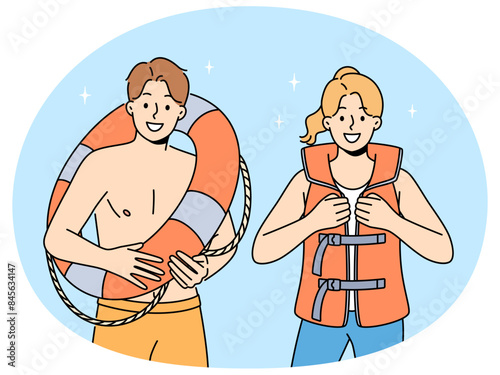 Smiling people in lifejacket and lifebuoy working on seashore. Happy lifeguards in inflatable vest and ring. Life saving and occupation. Vector illustration.