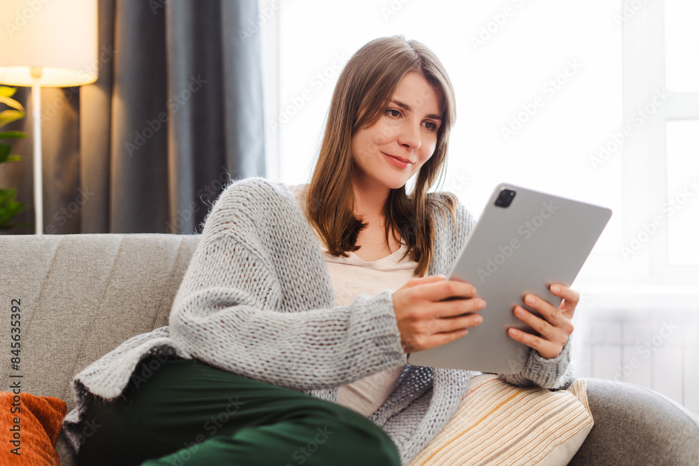 Beautiful woman, female manager, freelancer holding digital tablet, using, ordering, checking mail Beautiful woman, female manager, freelancer holding digital tablet, using, ordering, checking mail