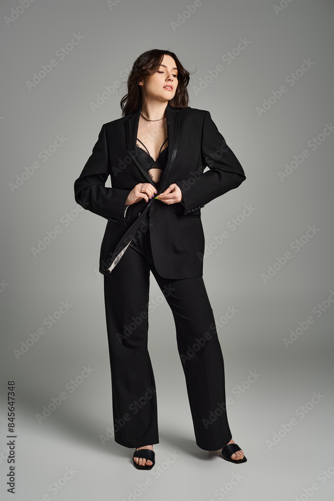 A beautiful plus-size woman in a black suit striking a pose while holding a sharp knife, exuding elegance and danger. A beautiful plus-size woman in a black suit striking a pose while holding a sharp knife, exuding elegance and danger.