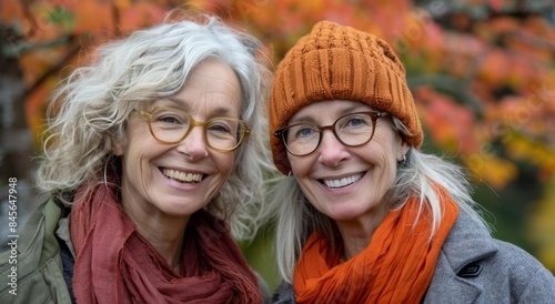 Two Women Smiling in Autumn With Orange Hats and Scarves