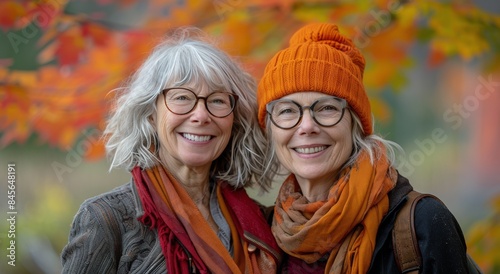 Two Women Smiling in Autumn With Orange Hats and Scarves