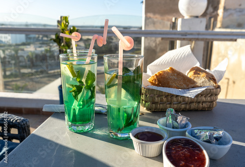 Moroccan hotel breakfast, also known as ftour, mint tea, bread basket, outdoor dining, morning meal photo