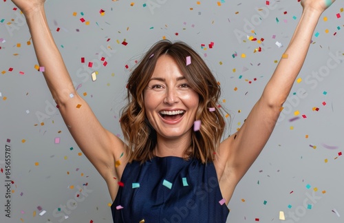 Woman Celebrates With Confetti and Raised Arms
