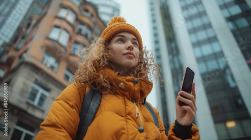 Young Woman Using Smartphone While Walking in City