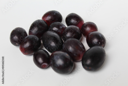 Dark purple or black grape group, off the stem, or without stalk, isolated on white background