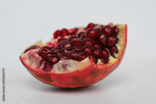 Inside of pomegranate fruit, fresh red seeds, isolated on white background photo