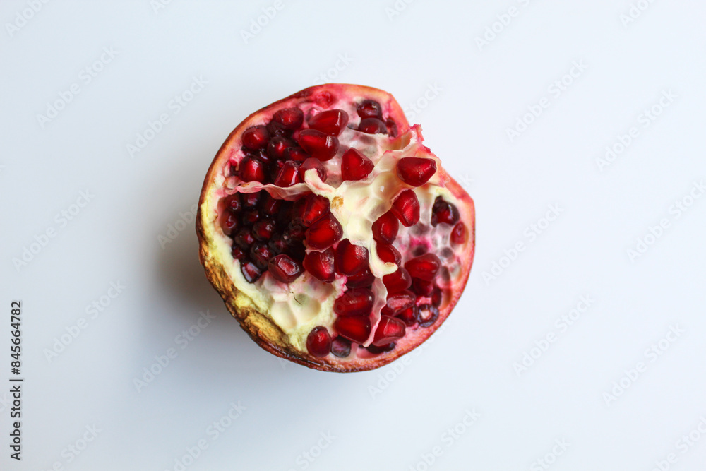 Inside of pomegranate fruit, fresh red seeds, isolated on white background