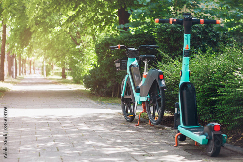 Bike and e Scooter for Rental. Bike Sharing Service.  Eco Transportation in Green City Street. 