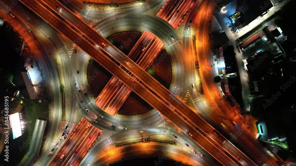 Financial technology, energy power, beautiful top view time-lapse of car traffic at roundabout lane and buildings. 4K drone aerial zoom out. Urban cityscape concept or abstract of advanced innovation.