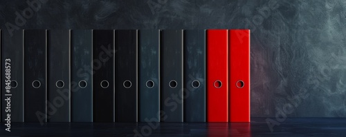 Stack of black and red file folders on dark background, office organization concept