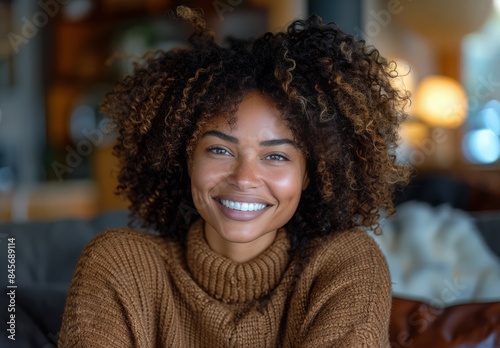 Smiling Woman With Curly Hair Wearing a Brown Sweater
