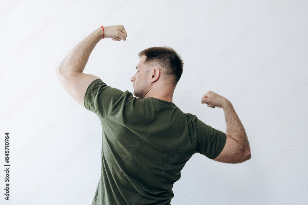 Strong man shows off pumped up biceps arms.