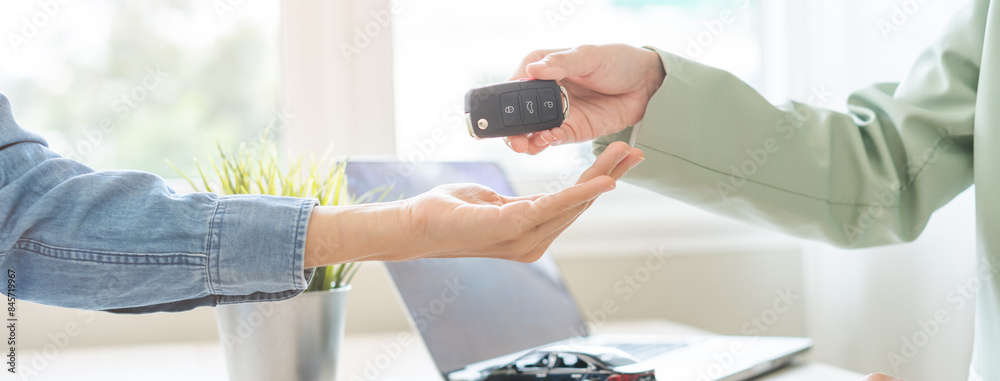 Business car rental, sell service, dealership hand of agent dealer, sell asian young woman giving auto key of vehicle to customer renter, female buyer receiving, client or tenant, transfer automobile. Business car rental, sell service, dealership hand of agent dealer, sell asian young woman giving auto key of vehicle to customer renter, female buyer receiving, client or tenant, transfer automobile.
