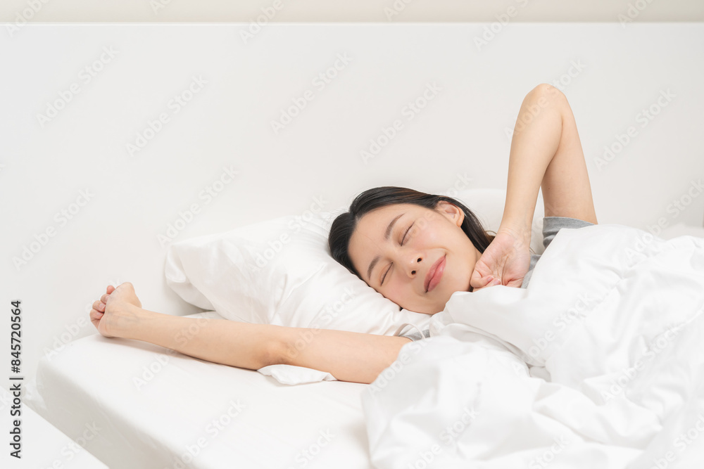 Wake up, beautiful stretching asian young woman waking up after sleep comfortable, rest and relax, closed eyes while with covered blanket, girl stretch in her bedroom,in cozy white bed in the morning. Wake up, beautiful stretching asian young woman waking up after sleep comfortable, rest and relax, closed eyes while with covered blanket, girl stretch in her bedroom,in cozy white bed in the morning.